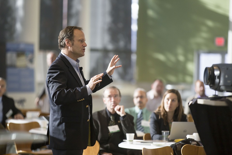 man speaking to a large group